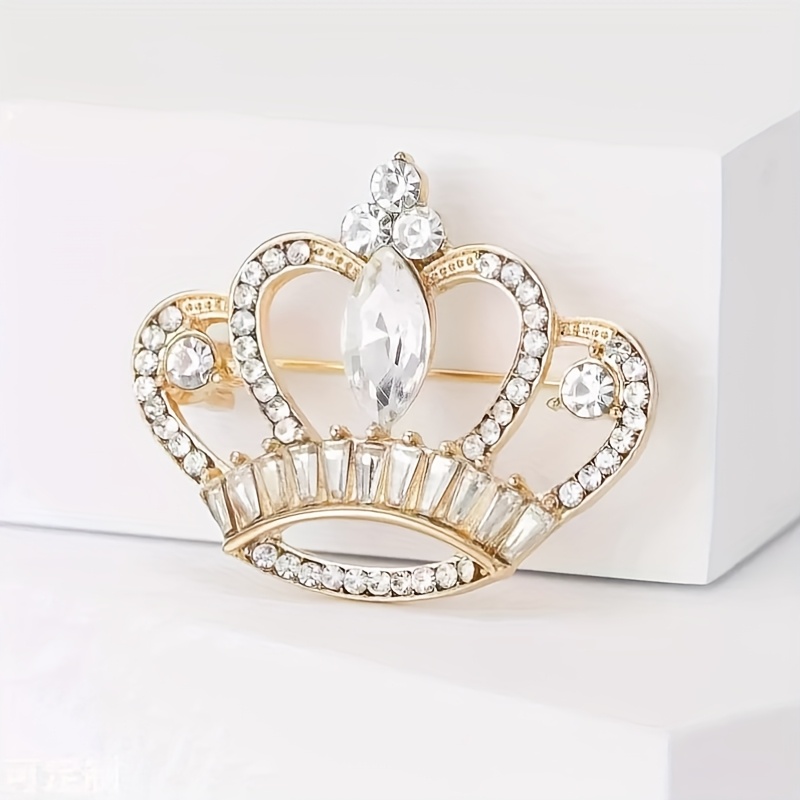 Gold-tone crown brooch with clear crystal-style accents